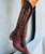 The Old Gringo Mayra Brass Boots are just another example of a masterpiece from the Old Gringo Boot Company. The Mayra Boots have been handcrafted from the softest, most beautiful brass brown leather you've ever seen or felt. The 18-inch boot shaft has been decorated with beautiful whimsical embroidery etched in shiny, golden-brown thread. 