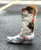 The Old Gringo Sozey Crystal Boots are made from soft brass brown vintage leather. The dark distressing mixes beautifully with the light brown, making these boots the ideal match for any outfit. The Sozey Boots have been decorated with multi color floral embroidery and small crystal stud accents throughout. The funky flowers are etched in bright colors like red, pink, green, teal, orange, and blue. These Old Gringo Boots would be perfect to wear during the Spring and Summer with a Sundress, or you can let them carry you into Fall and Winter with Jeans or Leggings. The boot shaft measures 13 inches, she ends in a pointed snip toe, and comes with boot pulls for easy pull on. Let these flirty, colorful Sozey boots, handcrafted by Old Gringo, be your best new accessory.