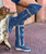 The Coleen boot is a must-have in the wardrobe of every loyal customer of El Vaquero brand. This double layered over-the-knee boot showcases the brand\'s signature handmade stitching on the instep, exquisite fringe detailing and an elegant lace-up back. Crafted with impeccable quality and attention to detail, the Coleen boot will enhance your look with sophistication and flair. Created in this totally new material, the Atomic Jeans is expertly crafted from prime quality brushed leather combined with denim. The cowhide details with ethnic motifs and the vintage effect created by the rips and by our stone-wash treatment make it incredibly revolutionary and destined to change the world of Jeans.