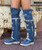 The Coleen boot is a must-have in the wardrobe of every loyal customer of El Vaquero brand. This double layered over-the-knee boot showcases the brand\'s signature handmade stitching on the instep, exquisite fringe detailing and an elegant lace-up back. Crafted with impeccable quality and attention to detail, the Coleen boot will enhance your look with sophistication and flair. Created in this totally new material, the Atomic Jeans is expertly crafted from prime quality brushed leather combined with denim. The cowhide details with ethnic motifs and the vintage effect created by the rips and by our stone-wash treatment make it incredibly revolutionary and destined to change the world of Jeans.