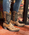 Take a crowd favorite and just punch it up a little...that's what you'll find in the Old Gringo Polo Chale with Distressed Black shaft styling... Featuring fabulous, intricate, floral hand tooling all over you'll love the shorter,10" boot shaft, the easy walking heel, the leather braided accents, and chic rounded toe.

The perfect match for any Season and any outfit, the Polo Chale Boots will be a collection staple for years to come. If you're looking for a gorgeous pair of hand tooled tan distressed black leather boots with an amazing, unique, and timeless design then the Old Gringo Polo Chale is for you...and it's another Boot Junky original!Authentic leather ankle boots, western-inspired with hand-stitched detailing and an allover floral design. Embellished pull-tabs at topline. By Old Gringo
10 inch shaft

1.5-inch heel

Heel 9964 Walking Heel

Toe 4L Snip