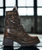 EMPER Calvados Rub-Off Metallic Lace-Up Boots
A masterclass in craftsmanship and character, the EMPER boots are built from genuine Italian leather with a hand-finished rub-off metallic treatment in rich Calvados — a deep, brandy-hued brown with an aged bronze undertone. The vintage patina plays against industrial edge, resulting in a boot that feels both heirloom and avant-garde. With a classic lace-up silhouette and subtly burnished details, they transition effortlessly from the streets of Milan to the rhythm of underground lounges.

Material: Premium Italian leather with rub-off metallic finish
Color: Calvados — warm brown with bronze/metallic sheen
Design: Lace-up, mid-calf height, lightly distressed for vintage flair
Vibe: Artisanal rebel meets modern classic
Crafted in: Italy