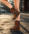 Arya in Leomarble – The Icon of El Vaquero
An enduring symbol of El Vaquero’s spirit, Arya has become the unmistakable icon of the brand — the embodiment of freedom, individuality, and untamed beauty. Crafted with impeccable quality and hand-finished artistry, this signature ankle boot features handmade stitching, side fringe, and nickel-free metallic accents, staying true to the brand’s heritage.

Now reimagined in Leomarble, an innovative blend of leopard and marble print, this seasonal edition arrives in a warm autumnal orange-brown hue. Lightly washed and vintage treated, the result is a bold yet wearable design that perfectly fuses wild charm with refined craftsmanship.

With a hidden 7 cm (2¾") internal wedge, Arya delivers a flattering silhouette without compromising comfort — making it a statement boot for every free-spirited soul.

Product Details:

Internal Wedge: 7 cm (approx. 2¾")

Leather: 100% calf suede

Print: Leopard-marble fusion (Leomarble)

Finish: Light vintage wash

Construction: Handcrafted stitching

Embellishments: Side fringe, 100% nickel-free metallic details

Sole: Rubber