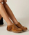 Note - Custom Order sizes due to arrive 60-90 days from order date. 

Bella is the new moccasin shoe from El Vaquero, combining everyday comfort and authentic artisanal style. Featuring cutouts on the upper, fringed backing, and hand-stitched seams, it offers a soft footbed and a rubber sole for a sophisticated, boho look. Crafted from this suede calfskin with a vintage finish, enhanced by the renowned Silverstone wash. Each hide is unique, with intense hues and a worn-in look that tells a story.

PRODUCT DETAILS

Moccasin Sneaker
Vintage Treatment
100% Calf Suede
100% nickel-free metal details
Leather details
Rubber sole
Made in Italy