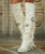 The Coleen Boot by El Vaquero is a true wardrobe essential for lovers of iconic Italian craftsmanship and timeless bohemian style. Defined by its double over-the-knee shaft, Coleen makes a striking statement while maintaining an elegant, refined silhouette.

Signature handcrafted stitching, soft side fringe, and graceful back lacing highlight the artisanal attention to detail El Vaquero is known for. Crafted in Italy from incredibly soft natural white calfskin, this luxurious leather brings a fresh, minimalist edge to a bold design — effortlessly blending modern sophistication with a free-spirited soul.

A 7 cm internal wedge provides subtle lift and all-day comfort, while the vintage treatment adds character and depth to the leather, ensuring each pair feels truly unique. Whether styled with flowing layers or clean, tailored pieces, Coleen is a timeless statement boot designed to elevate any look.

Details:

Double over-the-knee silhouette

Internal wedge: 7 cm

Vintage treatment

100% calfskin leather

Handcrafted stitching

Side fringe and back lace detailing

100% nickel-free metal hardware

Rubber sole

Made in Italy
