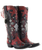These boots are a bold, statement-making pair of western showstoppers that fuse classic cowboy craftsmanship with edgy, artistic detail ?✨

Crafted in a rich two-tone leather combination, the base features deep chocolate brown paired with a striking turquoise crackled finish that gives a vintage, worn-in character.

Key Design Features:
Intricate inlay and embroidery work in turquoise, creating flowing, western-inspired patterns along the shaft and vamp
Mixed metal embellishments, including studs, domed hardware, and decorative accents that add texture and dimension
Prominent cross appliqués and concho-style details, giving the boots a bold, southwestern, almost heirloom feel
A studded center seam running vertically up the shaft for added edge and structure
Subtle distressing throughout for that perfectly broken-in, authentic look
Silhouette & Structure:
Classic snip/pointed toe for a sharp, feminine western profile
Mid-height stacked heel that’s both flattering and wearable
Tall shaft designed to stand out whether paired with denim or dresses
Overall Vibe:

These boots blend rock-and-roll western attitude with artisan craftsmanship—perfect for someone who wants a standout, collectible piece. They feel equal parts vintage, rebellious, and luxurious, making them the kind of boots that instantly elevate any outfit