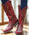 These boots are a bold, head-turning statement piece—rich in color, texture, and intricate detail ❤️‍??

Overall Look

Crafted from deep red distressed leather, these tall western boots have a striking, worn-in character that gives them instant vintage appeal. The silhouette is classic cowgirl with a slim shaft, pointed toe, and stacked heel, but the detailing takes them to another level.

Design Details
Intricate gold embroidery flows throughout the shaft and vamp in elegant, swirling patterns, adding a touch of feminine artistry
Rows of metallic studs trace curved panels along the sides, creating movement and dimension while adding a subtle edge
The studwork forms bold, sculptural shapes that frame the boot and draw the eye from top to toe
A snip toe and slightly angled heel give them that sleek, flattering western profile
Texture & Finish
The leather has a softly distressed, almost burnished finish, enhancing the rich red tones with depth and variation
Studs bring in a mix of matte and shine, contrasting beautifully against the warm leather
Styling Vibe

These boots feel like the perfect blend of romantic western and rock ‘n roll attitude—ideal with denim, dresses, or anything that calls for a standout piece. They’re confident, feminine, and undeniably eye-catching