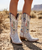Old Gringo – Austin Boots | Pink/Purple

This is Austin—and we sure do love her. ? New from Old Gringo Boots, this joyful standout is bursting with country-western charm and fearless color. Rich mulberry pink and purple leathers set the stage for an explosion of details, accented with pops of turquoise and yellow for a look that’s bold, playful, and undeniably fun.

Stars, hearts, arrows, florals, gleaming studs—Austin has it all. Finished with full side zippers for easy on-and-off and designed in a flattering mid-calf silhouette, she’s effortlessly wearable year-round. Whether styled with denim, dresses, or cutoffs, these boots deliver the perfect cowgirl statement every time.

Measurements:

Shaft Height: 12"

Shaft Opening: 13.5" circumference

Heel Height: 1 ¾"

Toe: Snip

Bright, spirited, and full of personality—Austin is western style with a wink. ?✨