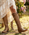 This brown tall boot combines style and sophistication with its rich color and sleek design. Its height flatters the legs, making it versatile enough to pair with jeans or dresses. Crafted from high-quality materials, this boot is a must-have for any wardrobe, offering comfort and confidence for any occasion.