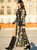 Turn heads wherever you roam in the Midnight Wildflower Duster, a breathtaking statement piece that blends Western romance with bohemian elegance. Crafted from sheer black mesh, this dramatic floor-length duster is adorned with dimensional embroidered wildflowers in shades of lavender, periwinkle, sage, gold, ivory, and turquoise, creating the look of a moonlit garden in full bloom.

The structured denim-inspired bodice features classic snap-front styling, flap chest pockets, and distressed raw-edge detailing, while the flowing embroidered mesh skirt adds movement and drama with every step. Sheer sleeves showcase the intricate floral embroidery, making this piece feel equal parts couture and cowgirl.

Layer it over a simple tank and denim, pair it with a slip dress, or style it with your favorite Old Gringo, El Vaquero, or Double D Ranch boots for an unforgettable boho-Western look.