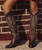 create an image with the full body view of a model in her mid twenties with long highlighted hair and give her a boho western vibe...have her wearing the boots in the 2 thru 4 images, styled together...use the styling of the attached reference images