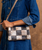 Cadence PW is a versatile 3-in-1 essential designed to move with you. Crafted from full-grain, vegetable-tanned leather in a distinctive patchwork exterior, it brings added depth and dimension to a signature silhouette. It transitions effortlessly from wallet to clutch to crossbody with an adaptable strap. Inside, two zippered pockets and dedicated card slots keep everything neatly in place, finished with a secure magnetic closure for a polished, uncomplicated carry.