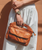 Greenway is designed for streamlined carry with security built in. Crafted from full-grain, vegetable-tanned leather, it offers a balanced silhouette that feels light in hand yet purposeful in presence. Dual top handles and a removable crossbody strap allow for flexible wear, while a secure zip-top closure keeps essentials protected. Interior and exterior zip pockets provide thoughtful organization without added bulk, making Greenway an effortless companion for everyday movement.