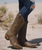 Old Gringo Nevada 13" Cowboy Boots – Gold/Tan

A little vintage soul, a touch of golden glamour, and unmistakable Old Gringo artistry.

Meet Nevada by Old Gringo—a beautifully handcrafted Western boot that captures the romance of the Old West with an effortlessly sophisticated twist. Rich gold and tan leather tones come together in a gorgeous distressed finish, creating a warm, weathered look that feels like a treasured vintage find.

Intricate embroidery brings artistry and dimension to the classic 13-inch silhouette, while the feminine snip toe and beautifully proportioned heel add just the right amount of cowgirl attitude. Every detail celebrates the character and craftsmanship that make Old Gringo boots so collectible.

Crafted from 100% genuine leather, Nevada features a smooth leather lining, cushioned insole, and traditional leather outsole for comfort and durability. Convenient side zippers make slipping into these beauties a breeze, while the rubber heel caps provide added practicality.

Pair Nevada with your favorite worn-in denim, a flowing bohemian dress, or a romantic lace skirt. Whether you're dressing for a casual afternoon or a night out, these golden beauties bring a little Western magic to every outfit.

Boot Details

Brand: Old Gringo

Style: Nevada

Color: Gold/Tan

Shaft Height: 13"

Heel Height: 1.625" (approximately 1⅝")

Toe: Snip Toe

Width: Standard Women's B

Upper: 100% Genuine Leather

Lining: Smooth Leather

Insole: Soft, Cushioned Insole

Outsole: Leather with Weathered Snow Finish

Heel Cap: Rubber

Closure: Side Zippers

Design Details: Distressed Leather and Intricate Western Embroidery

The Boot Junky Take: Nevada is the kind of boot that only gets better with time. Her golden hues, vintage-inspired finish, and beautiful embroidery make her a versatile addition to any cowgirl's collection—and a style you'll reach for season after season.