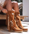 Description
The Billie mid-calf boot by El Vaquero is where free-spirited style meets artisanal craftsmanship. Designed with a comfortable 2 ¾" hidden internal wedge, Billie delivers effortless lift while keeping all-day wearability front and center.

Soft, flowing fringe, beautifully crafted leather side tabs, and the brand’s signature thick hand-stitched toecaps create a look that’s both iconic and unmistakably El Vaquero. Finished in the celebrated Silverstone wash, this boot reveals rich, dimensional color variations that enhance every nuance of the suede—ensuring no two pairs are ever exactly alike.

Vintage-treated 100% calf suede, meticulous handcrafted stitching, and refined metallic accents come together for a timeless yet edgy silhouette that transitions seamlessly from everyday wear to elevated boho styling.

Details:

2 ¾" hidden internal wedge

Vintage treatment

100% calf suede

Handcrafted stitching

100% nickel-free metallic details

Rubber sole