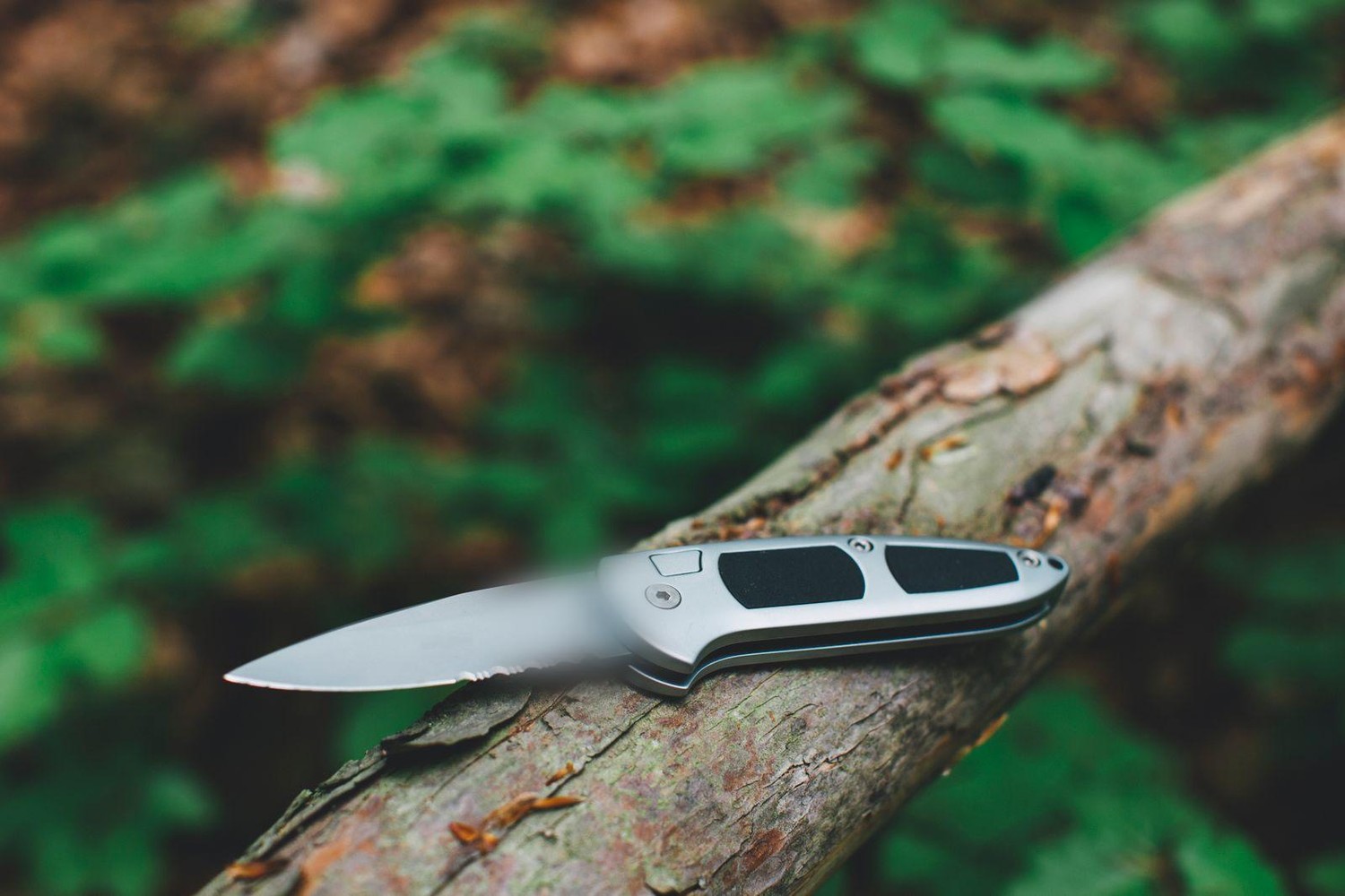 Folding knife resting on weathered wood