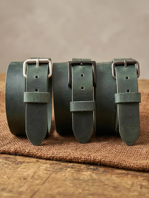 Three buckle options for Crazy Horse Green leather belt: Matte Black Pin, Gunmetal Roller, and Antique Nickel Roller