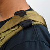 Strike Industries SI-SLING-CATCH Sling Catch, close-up view of the tactical sling catch device attached to a military-style sling on a person's shoulder.