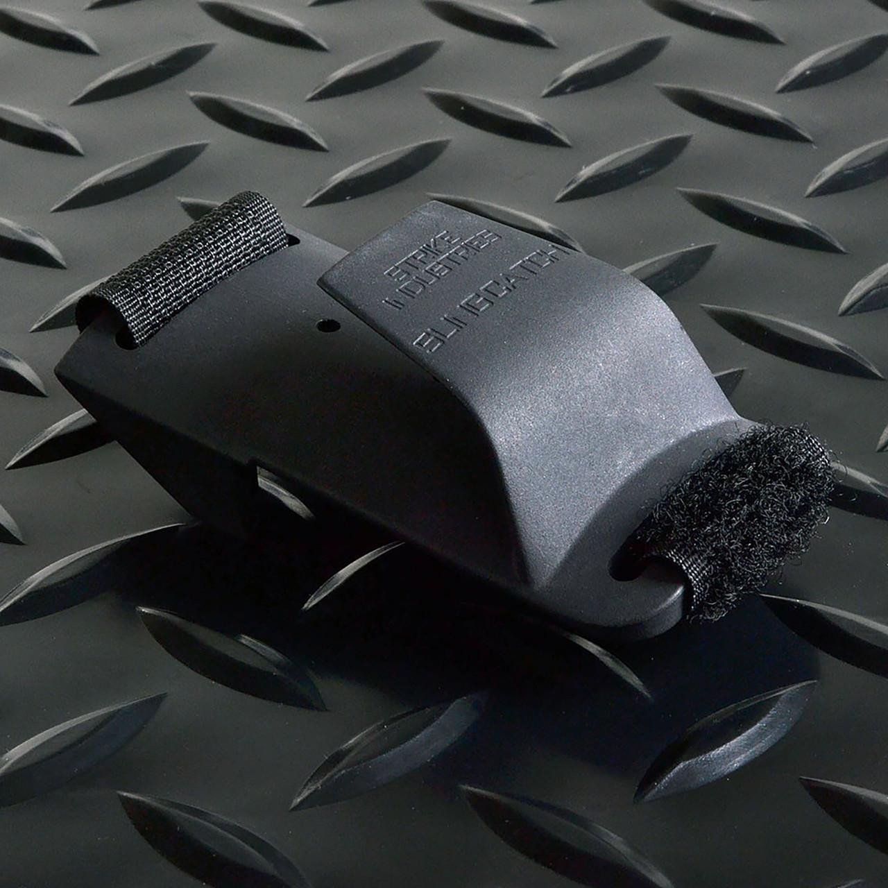 Strike Industries SI-SLING-CATCH Sling Catch, black sling catch device with adjustable straps on a textured metal surface.