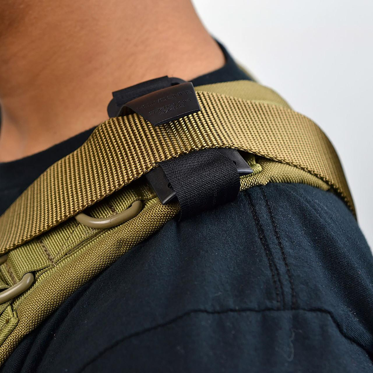 Strike Industries SI-SLING-CATCH Sling Catch, close-up view of the tactical sling catch device attached to a military-style sling on a person's shoulder.
