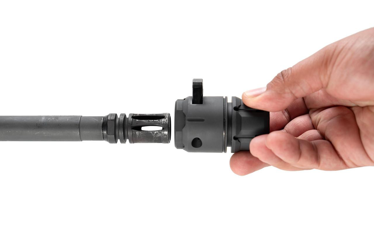 Strike Industries SI-BS-NATO-BK Blast Shield for A2 Birdcage Flash Hider, black blast shield being attached to a rifle's flash hider.