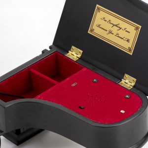 music box with an engraved plaque and red felt interior