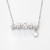 Platinum Plated Necklace with Pendant that reads "Dream" with White Gemstones