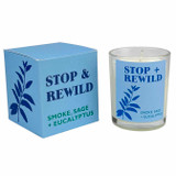Heaven Scent Modern Botanical Stop & Rewild candle in glass jar next to its blue box with botanical illustration. Scent notes: Smoke, Sage and Eucalyptus. Vegan soy wax.