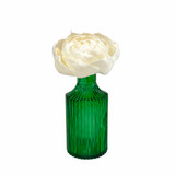 Empty vintage style green bottle for reed diffusers, posies and decoration photographed with a Peony sola flower.