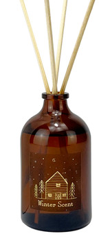 Heaven Scent Christmas Winter Scent diffuser in a a brown apothecary bottle with gold label depicting a lodge printed in gold.
