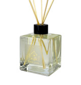 Heaven Scent Christmas Winter Scent diffuser in a square glass bottle with gold label depicting a lodge printed in gold.