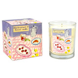 Blackcurrant & Sweet Vanilla scented 20cl candle in a clear glass vessel beside its matching illustrated gift box. The packaging features a hand-painted tabletop scene by Sarah Pettitt including a croissant, coffee pot and summer fruits on a pink checkered tablecloth.