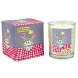 Pink Pepper & Bergamot scented 20cl candle in clear glass alongside its illustrated gift box. The artwork by Sarah Pettitt features a blue and white patterned vase containing red and yellow flowers, resting on a pink and white chequered surface with a lilac background.