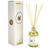 A Heaven Scent 100ml clear apothecary glass reed diffuser with four natural reeds, standing next to its tall white gift box. Both the bottle and box feature a delicate watercolour illustration by Sarah Pettitt of two turtle doves on a branch within a blue scalloped frame, alongside a small nest containing two eggs.