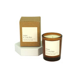 Amber and Tonka Bean vegan soy wax candle in a warm amber glass votive, shown with a beautiful luxury gift box.