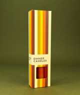 A beautifully illustrated, autumn-striped gift box for Heaven Scent's The Autumn Edit mixed dinner candles, displayed alongside six straight, hand-poured artisan dinner candles in complementary shades of Pumpkin Orange, Dark Brown and Burnt Orange.
