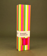 A beautifully illustrated, vibrantly striped gift box for Heaven Scent's The Neon Edit mixed dinner candles, displayed alongside six straight, hand-poured artisan dinner candles in electric shades of Neon Yellow, Neon Orange and Neon Pink.