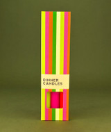 A beautifully illustrated, vibrantly striped gift box for Heaven Scent's The Neon Edit mixed dinner candles, displayed alongside six straight, hand-poured artisan dinner candles in electric shades of Neon Yellow, Neon Orange and Neon Pink.