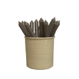 Several charcoal grey artisan dinner candles displayed together in a stylish ceramic pot, showcasing their deep shade and premium hand-poured finish.