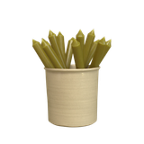 Several natural cream artisan dinner candles displayed together in a stylish ceramic pot, showcasing their soft shade and premium hand-poured finish.