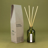 A 100ml luxury Elder Flower Green Botanical reed diffuser by Heaven Scent, housed in an elegant green apothecary glass bottle with natural rattan reeds, made in the UK.