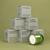 20cl natural soy wax Wild Plum scented candle in a beautiful green glass jar, next to its recycled presentation box, hand-poured in the UK.