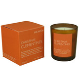 Christmas Clementines 20cl amber glass scented candle from the Modern Heritage collection, shown beside its orange gift box.