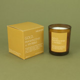 Gold, Frankincense & Myrrh 20cl amber glass scented candle from the Modern Heritage collection, shown beside its gold gift box.