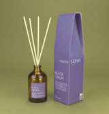 Black Opium 100ml amber apothecary glass reed diffuser from the Modern Heritage collection, shown with natural rattan reeds and its purple gift box.