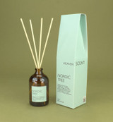 Nordic Tree 100ml amber apothecary glass reed diffuser from the Modern Heritage collection, shown with natural rattan reeds and its pale green gift box.