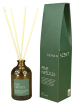 Pine Needles 100ml amber apothecary glass reed diffuser from the Modern Heritage collection, shown with natural rattan reeds and its green gift box.