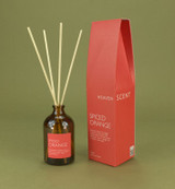 Spiced Orange 100ml amber apothecary glass reed diffuser from the Modern Heritage collection, shown with natural rattan reeds and its red gift box.