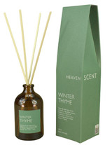 Winter Thyme 100ml amber apothecary glass reed diffuser from the Modern Heritage collection, shown with natural rattan reeds and its green gift box.
