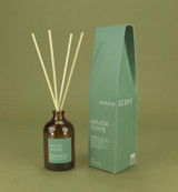 Winter Thyme 100ml amber apothecary glass reed diffuser from the Modern Heritage collection, shown with natural rattan reeds and its green gift box.